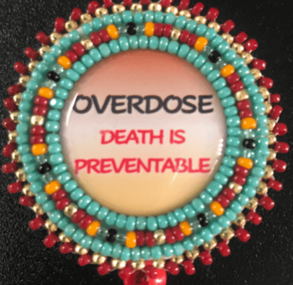 Beaded pin with message 'OVERDOSE DEATH IS PREVENTABLE'